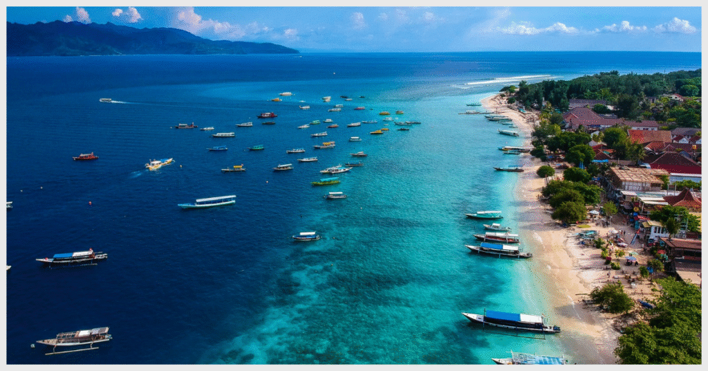 A scenic view of Gili Island's beach with boats gently bobbing in the clear ocean waters.