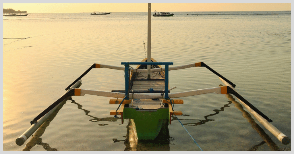 A boat anchored in the calm waters of Gili Island, surrounded by a serene tropical landscape.